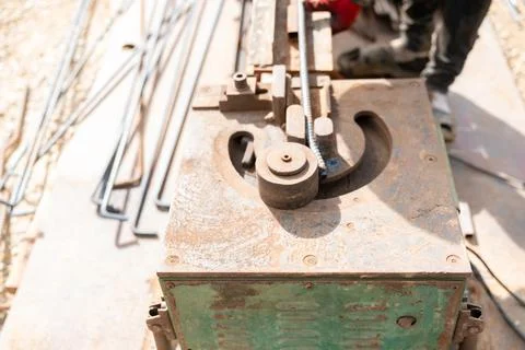 Top view of a rebar bending machine being used at a construction site. Stock Photos