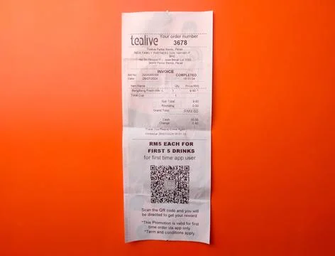 Top view receipt for the purchase of Tealive drinking water on an orange ba.. Stock Photos