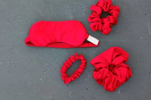 Top view red accessories sleeping mask on grey background Stock Photos