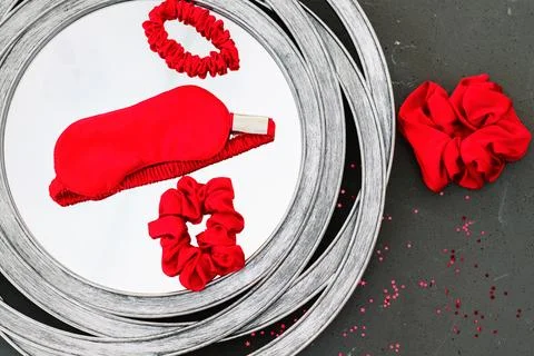 Top view red accessories sleeping mask on grey background Stock Photos