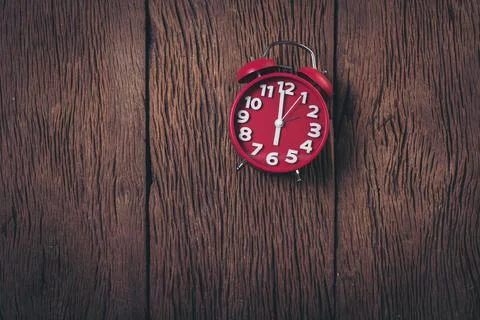 Top view red alarm clock on wood background Stock Photos