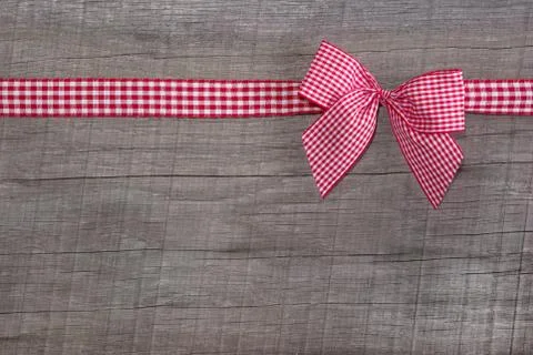 Top view of a red checked ribbon decoration on wooden background Stock Photos
