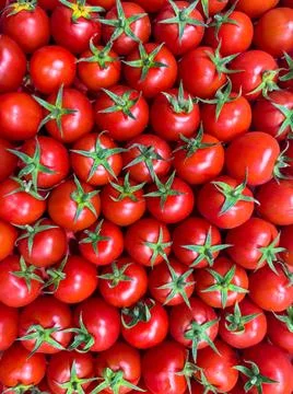 Top view of red cherry tomatoes with green stalk. Organic natural vegetables Stock Photos