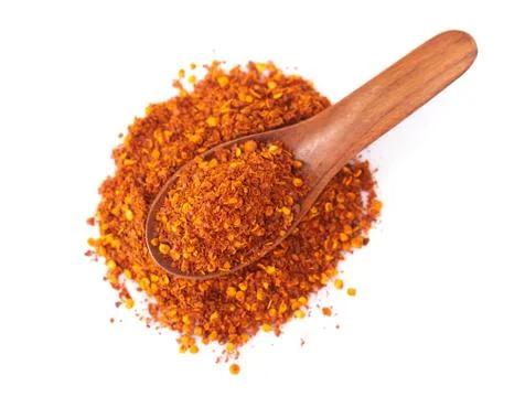 Top view red chilli power in wood spoon on white background, food ingredient Stock Photos