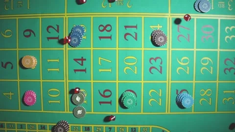 Top view of red dice falling and scattering in slow motion on a green roulette Stock Footage 187552728