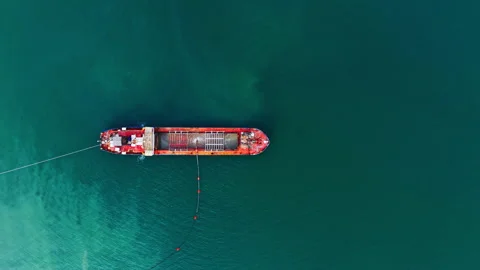 Top view of red dredging ship pumping sand through pipe Stock Footage 331943421