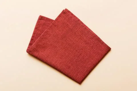 Top view with red empty kitchen napkin isolated on table background. Folded.. Stock Photos