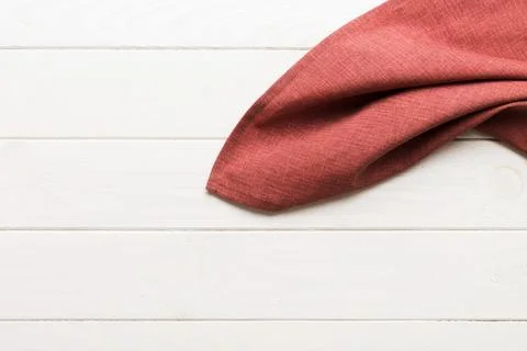 Top view with red empty kitchen napkin isolated on table background. Folded.. Stock Photos
