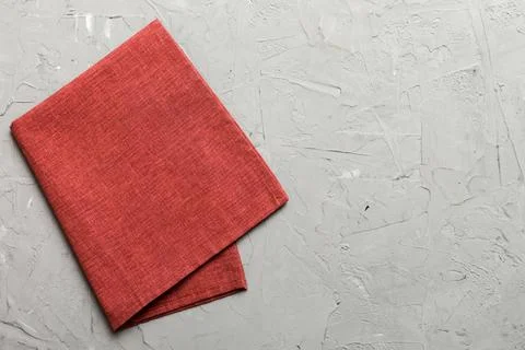 Top view with red empty kitchen napkin isolated on table background. Folded.. Stock Photos