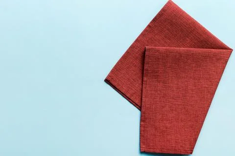 Top view with red empty kitchen napkin isolated on table background. Folded c Stock Photos