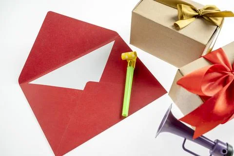 Top view of red envelope or postcard and gift box with plastic horn and par.. 写真素材