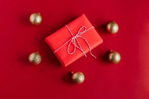 Top view red gift box and golden christmas balls on a red background Stock Photos