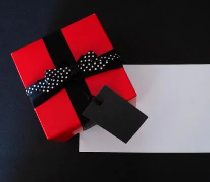 Top view of red gift box and empty sale price tag.Promotional sales. Stock Photos