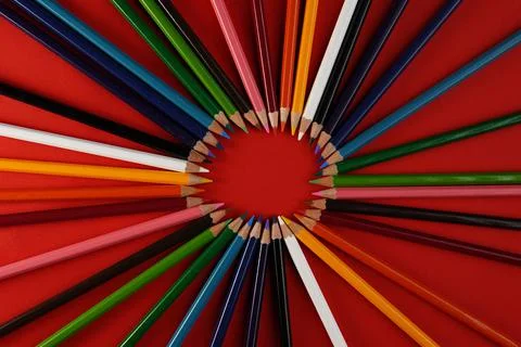 Top view on red paper with the set of colour pencils. Stock Photos
