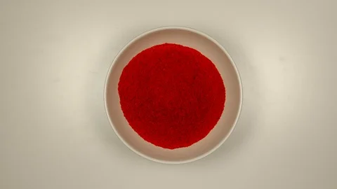 TOP VIEW: Red pepper powder fill a white bowl - Stop motion Stock Footage 121942979