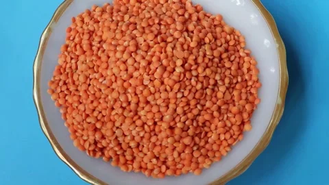 Top view of red raw lentils rotation on a bowl. Food background. Stock Footage 278343434