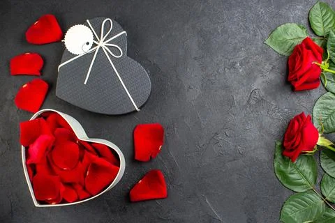 Top view red rose petals with red roses inside box for valentines day on da.. Stock Photos