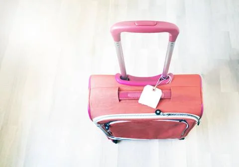  top view of a red suitcase with the handle raised and a blank label top v... Photos