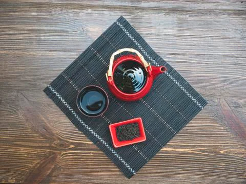 Top view. Red tea set on a wooden table. Red teapot, cup and chinese tea Stock Photos
