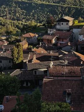 Top view of red tile roofs of traditional ancient Italian mountain village. T Stock Photos