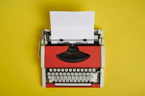 Top view of red vintage typewriter with white blank paper sheet Stock Photos
