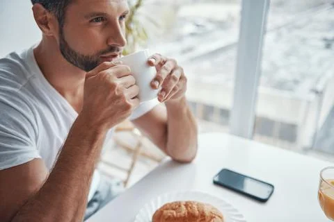 Top view of relaxed young man enjoying hot coffee Stock Photos