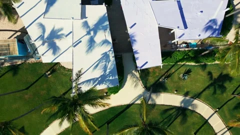 Top view: residence with paths and lawn into tourist beach with loungers merging Video stock 311340181