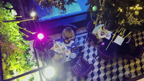 Top view of restaurant patrons at a table and a waiter. Stock-Footage 299717550