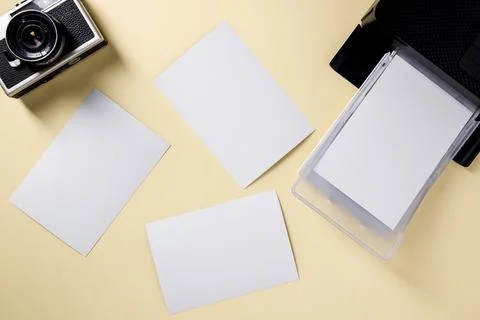 Top view of retro camera, blank photo papers and mobile photo printer Stock Photos