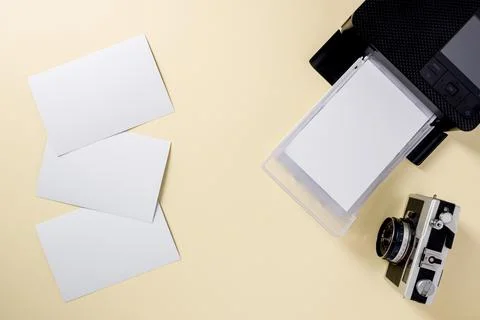 Top view of retro camera, blank photo papers and mobile photo printer Stock Photos