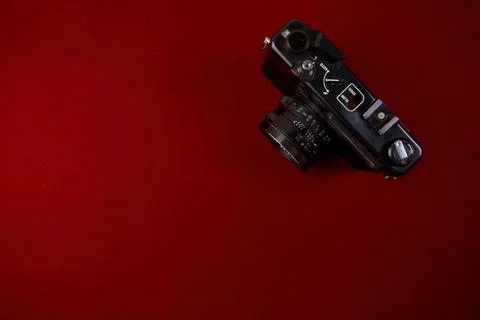 Top view of retro camera on red background with copy space Flat lay Stock Photos