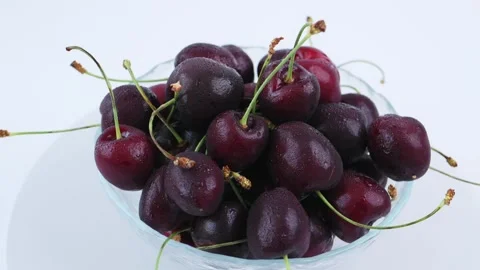 Top view ripe cherry clustered inside glass bowl against white background 4k Video stock 342964095