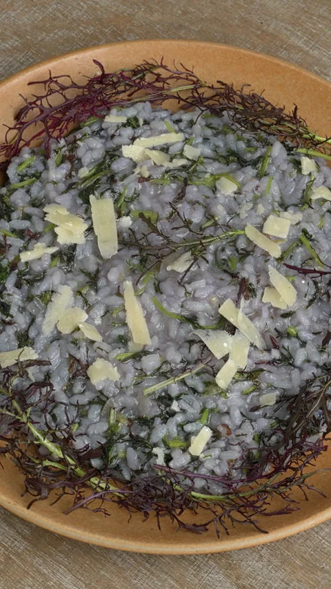 Top view of risotto with mizuna Red Frill variety. Vertical video. Video stock 292318492