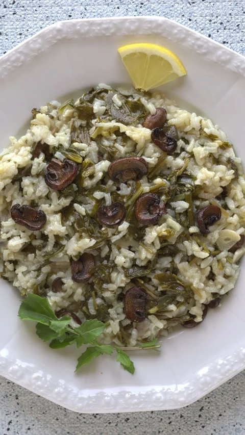 Top view of risotto with rocket and champignons on a plate. Vertical video. Stock Footage 311547055