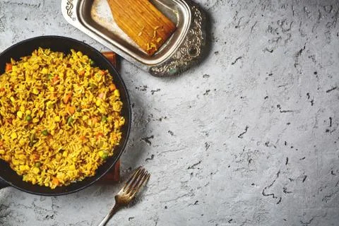Top view of a risotto with vegetables and vegan beet cutlets served on a black Stock Photos