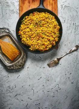 Top view of a risotto with vegetables and vegan beet cutlets served on a black Stock Photos