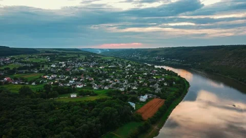 Top view of river and tiny houses in countryside full of green landscapes. Stock Footage 151492406