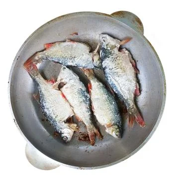 Top view of the river fish, which is fried in a round pan. Cooking in the fie Stock Photos