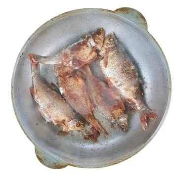 Top view of the river fish, which is fried in a round pan. Cooking in the fie Stock Photos