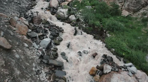 Top view river flows over rocks in the mountains Stock Footage 68635197