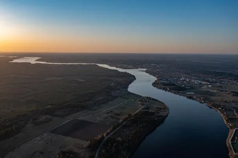 Top view of the River, surrounded by trees and meadows on its banks, view fro Photos