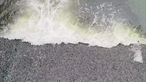 Top view of river water current flowing into a calm lake with white foam. Stock Footage 341155738