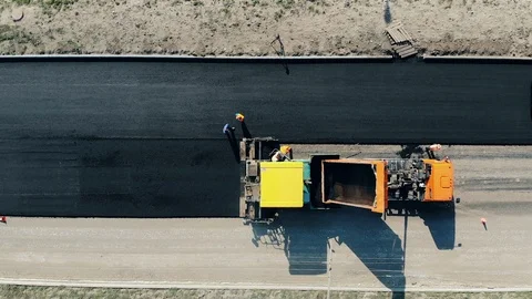 Top view of road makers spreading asphalt Video stock 119598527