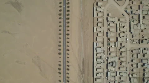 Top view of the road through the desert with palm trees and slums Stock Footage 264020741