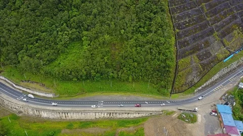 Top view of a road by a tree covered hillside Stock Footage 110932436