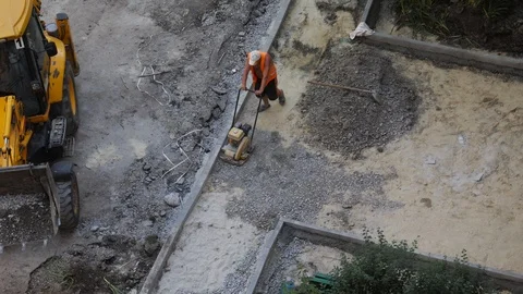 Top view. Road worker use heavy machinery pounding asphalt. Stock Footage 111836349