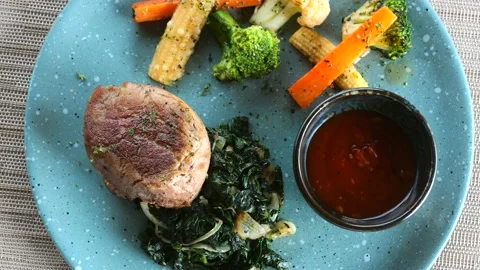 Top view of roasted beef steak with spinach and vegetables. Healthy meal with Stock Footage 198630436