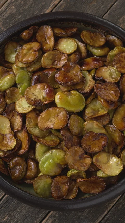 Top view of roasted broad beans in a bowl. Vertical video. Stock Footage 317020338