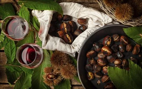 Top view of Roasted chestnuts in iron skillet on wooden table Stock Photos