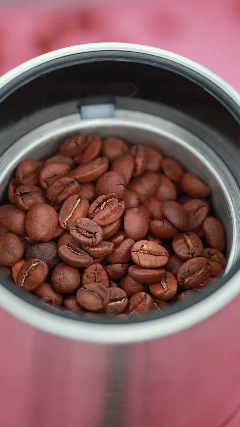 Top View Of Roasted Coffee Beans Inside A Stainless Steel Coffee Grinder. Vertic Stock Footage 294324937